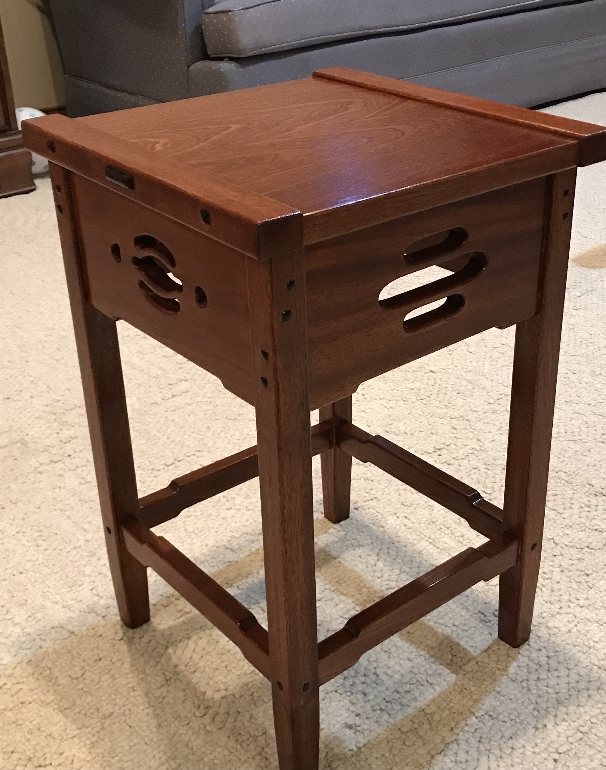 The varnished table top sitting on the legs